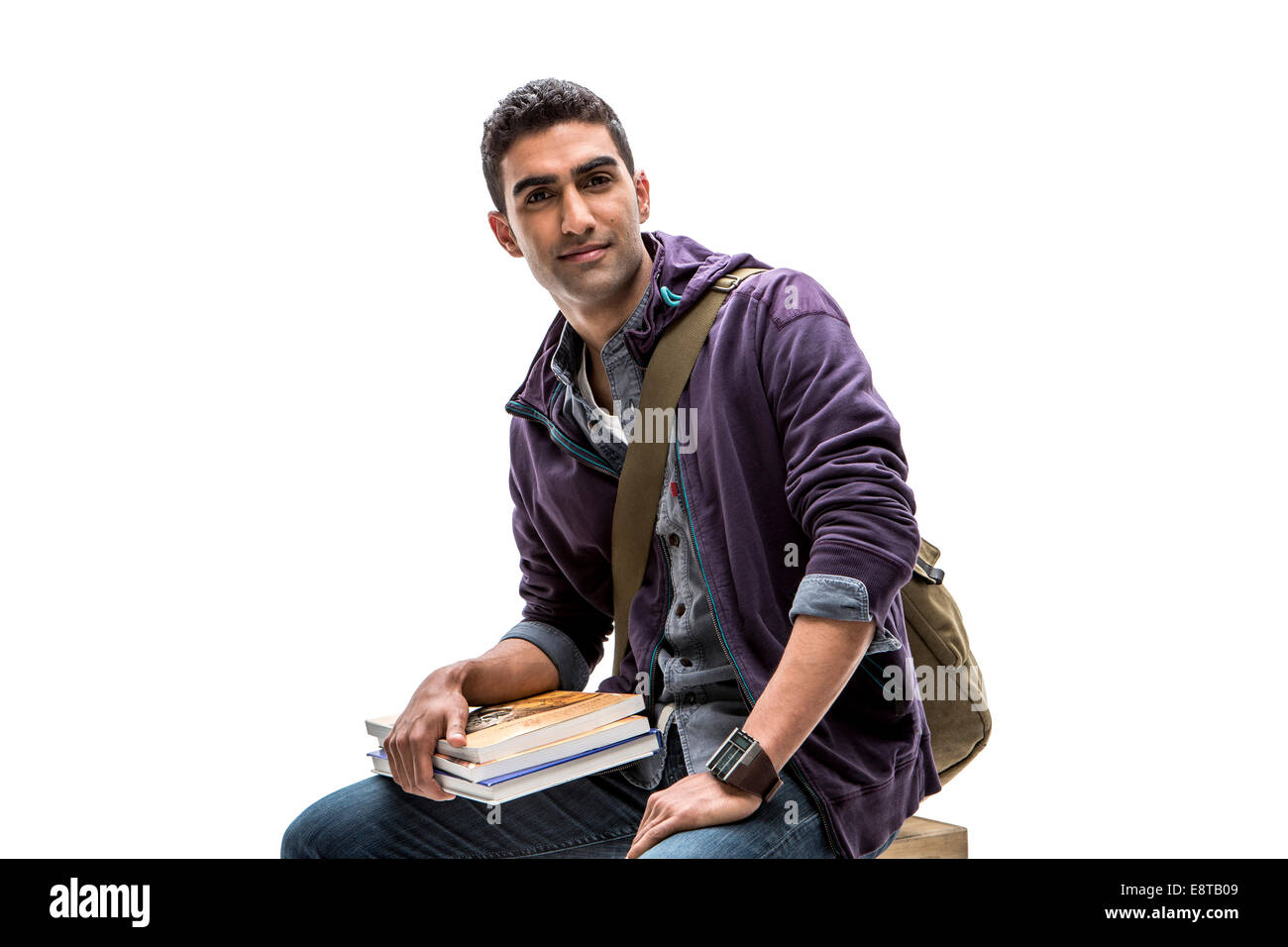 Indischer Student hält Stapel Bücher Stockfoto