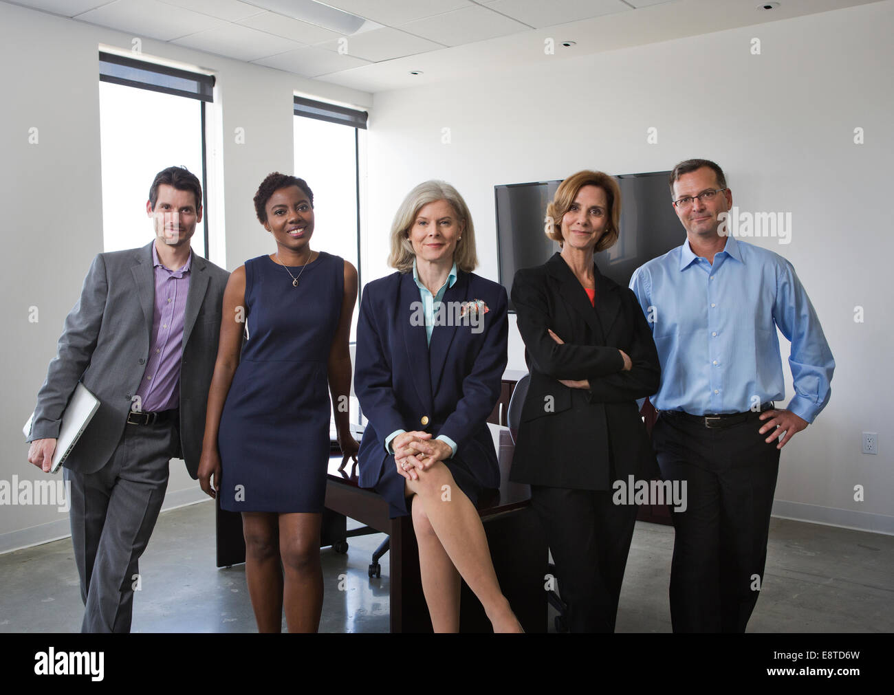 Geschäftsleute, die lächelnd zusammen im Büro Stockfoto