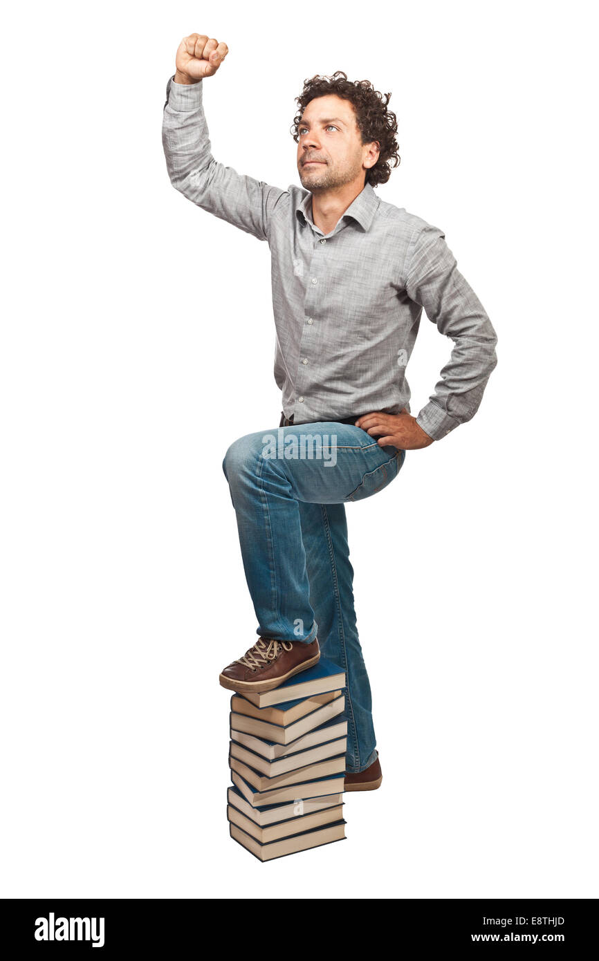 Gewinner-Mann und Stapel Bücher Stockfoto