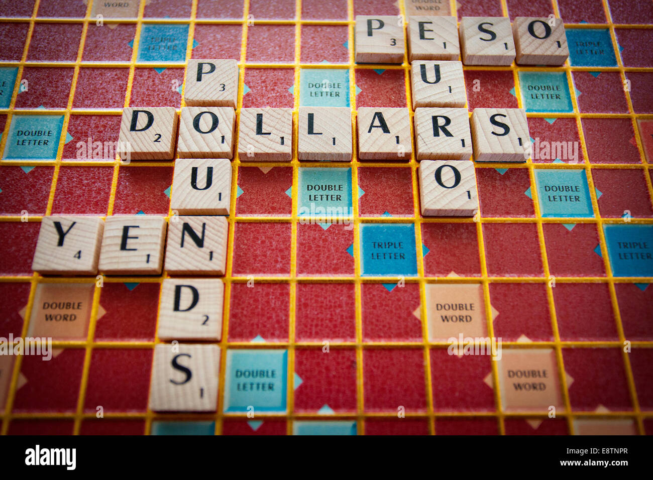 Verschiedenen Währungen der Welt auf einem Scrabble-Brett geschrieben Stockfoto