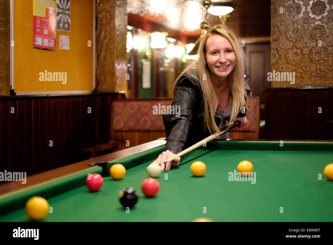 lächelnde junge Frau Billard in einem traditionellen britischen Pub der Eldon Arme Southsea England uk Stockfoto