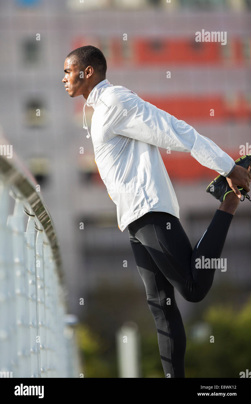 Menschen, die seine Beine vor dem Training zu dehnen Stockfoto