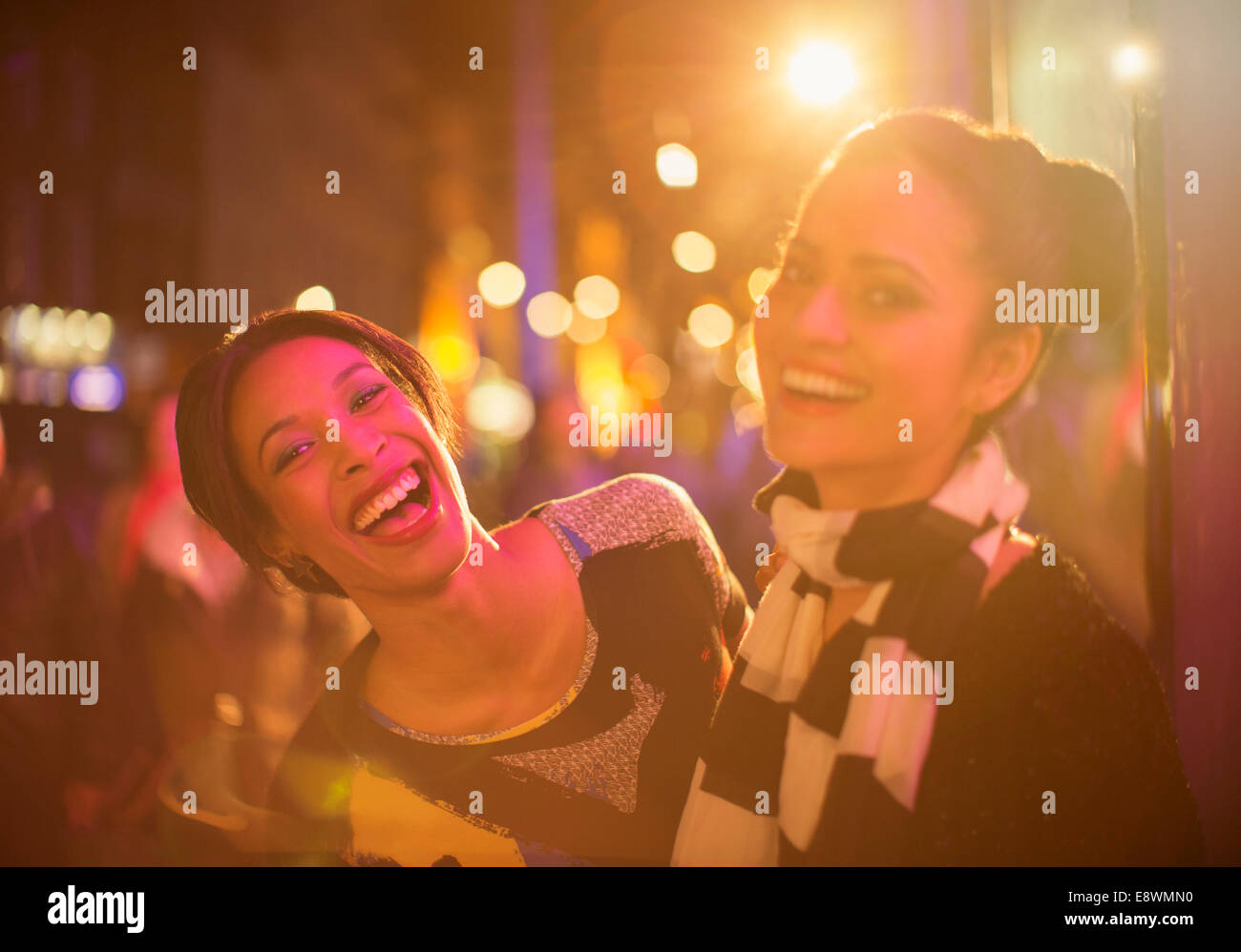 Freunde, die zusammen lachen auf Stadt Straße bei Nacht Stockfoto