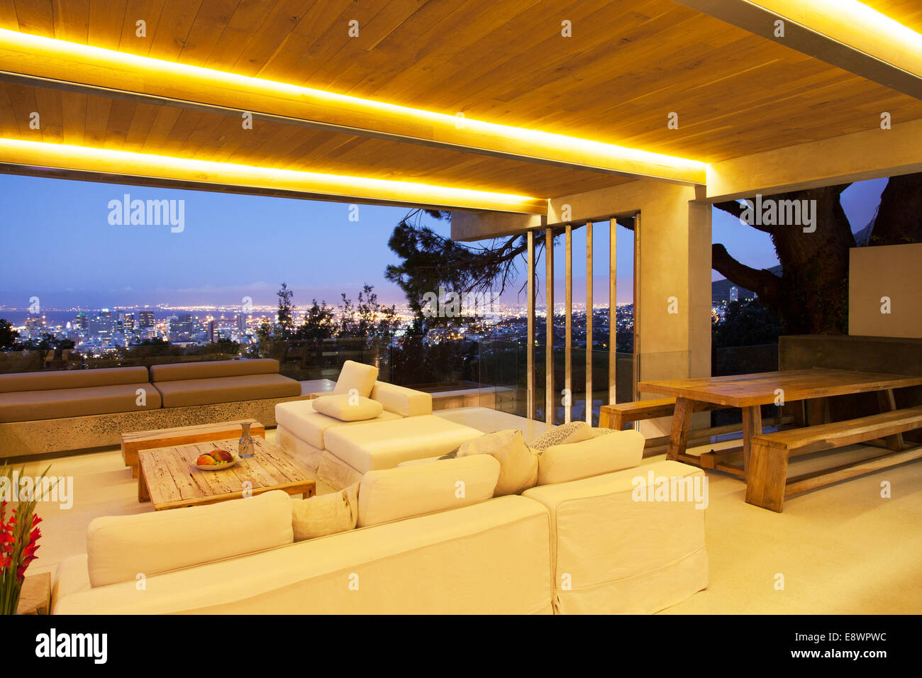 Modernes Wohnzimmer mit Blick auf beleuchtete Stadtbild bei Nacht Stockfoto