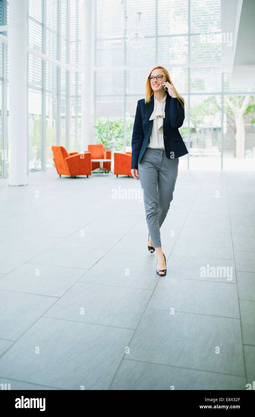 Geschäftsfrau, reden über Handy im Bürogebäude Stockfoto