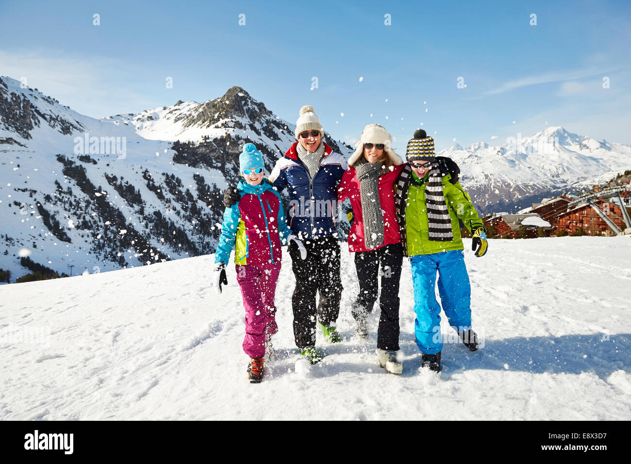 Familie, die zusammen durch den Schnee spazieren Stockfoto