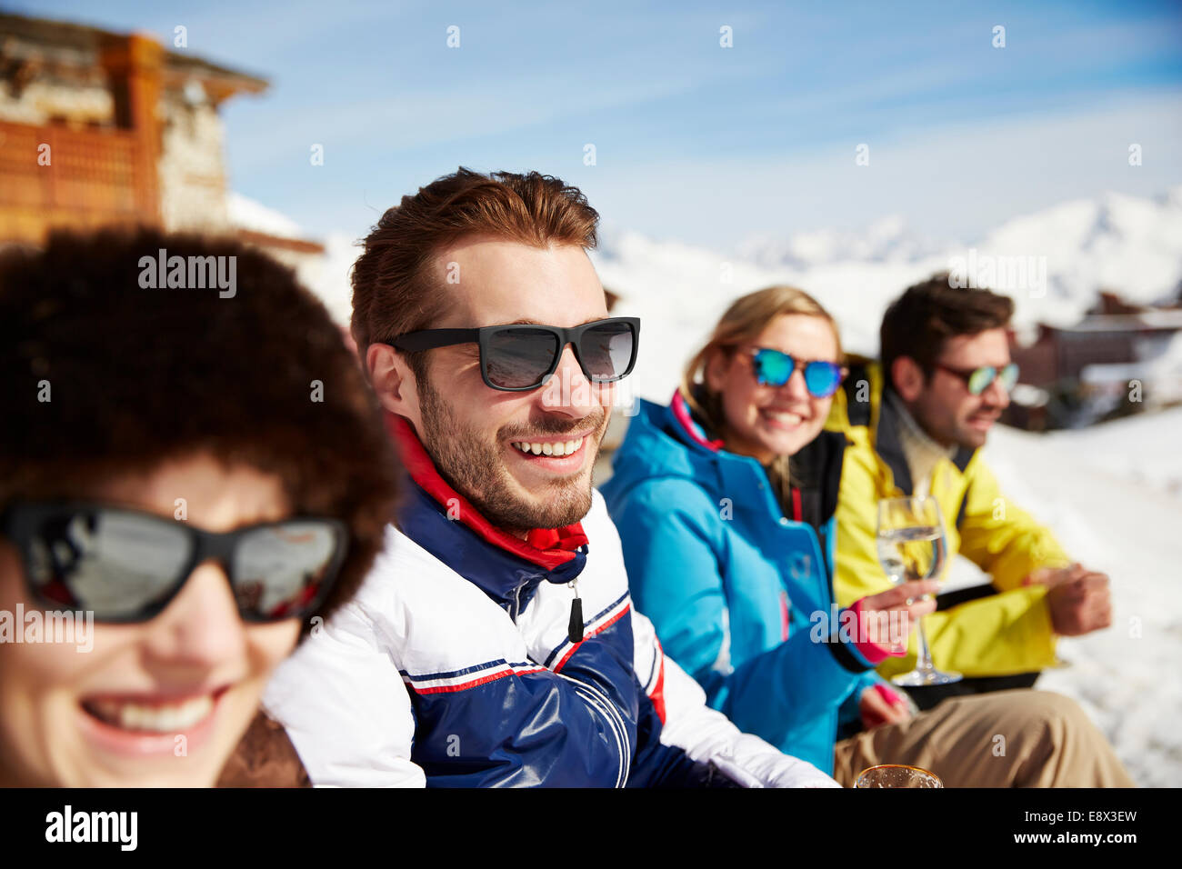 Freunde sitzen zusammen im Schnee Stockfoto