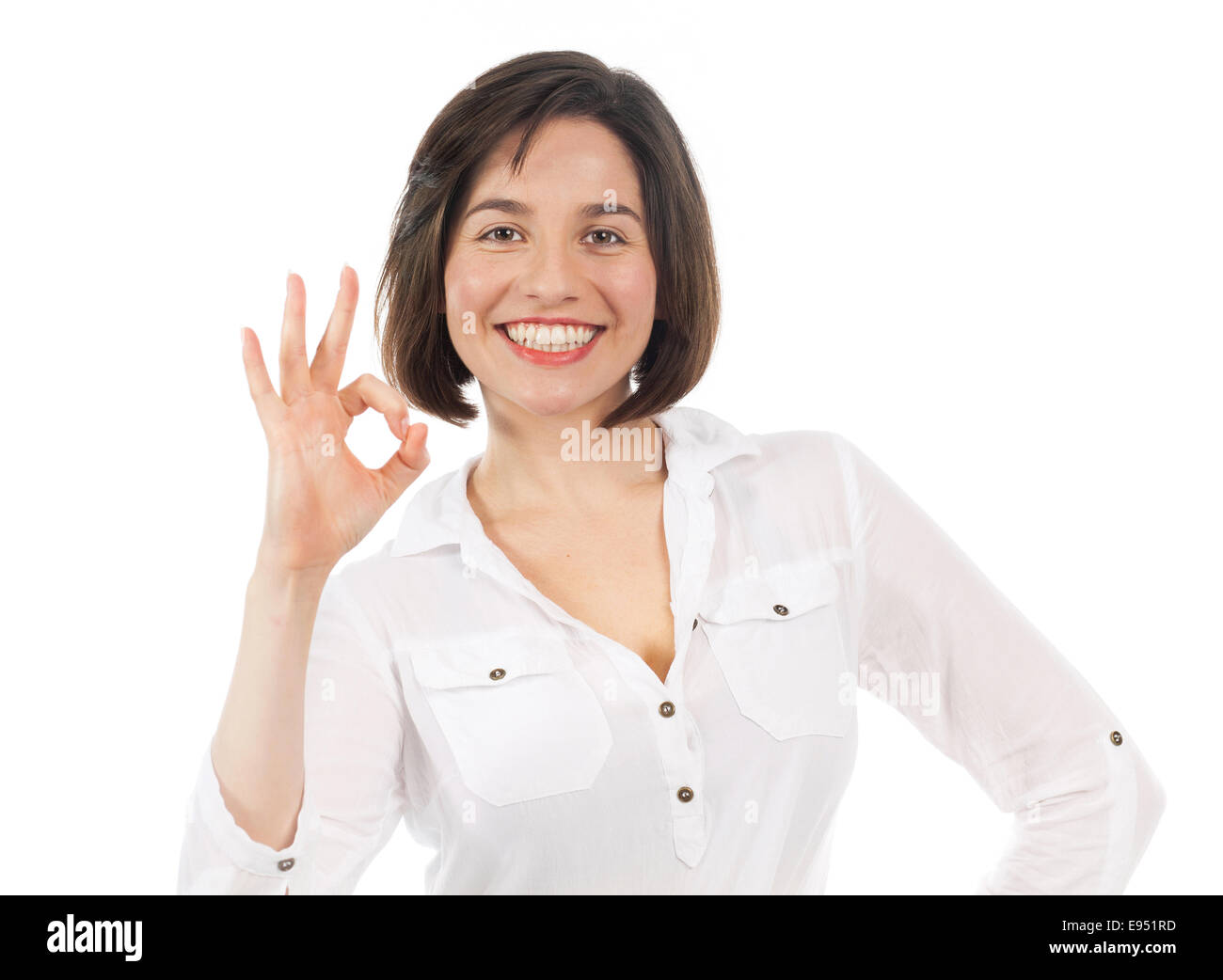 Porträt der jungen Frau, die eine positive Geste, isoliert auf weiss Stockfoto