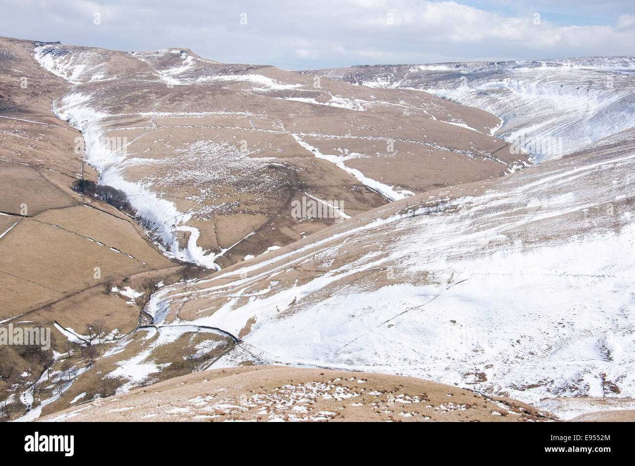 Verschneite Winterlandschaft spät in High Peak, Derbyshire. Schneeverwehungen in einem Moor-Szene. Stockfoto