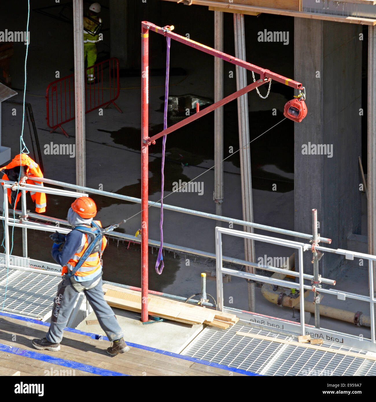 Herbst-Prävention-Rückhaltesystem gebräuchlich durch Arbeiter auf Podest auf Baustelle Stockfoto