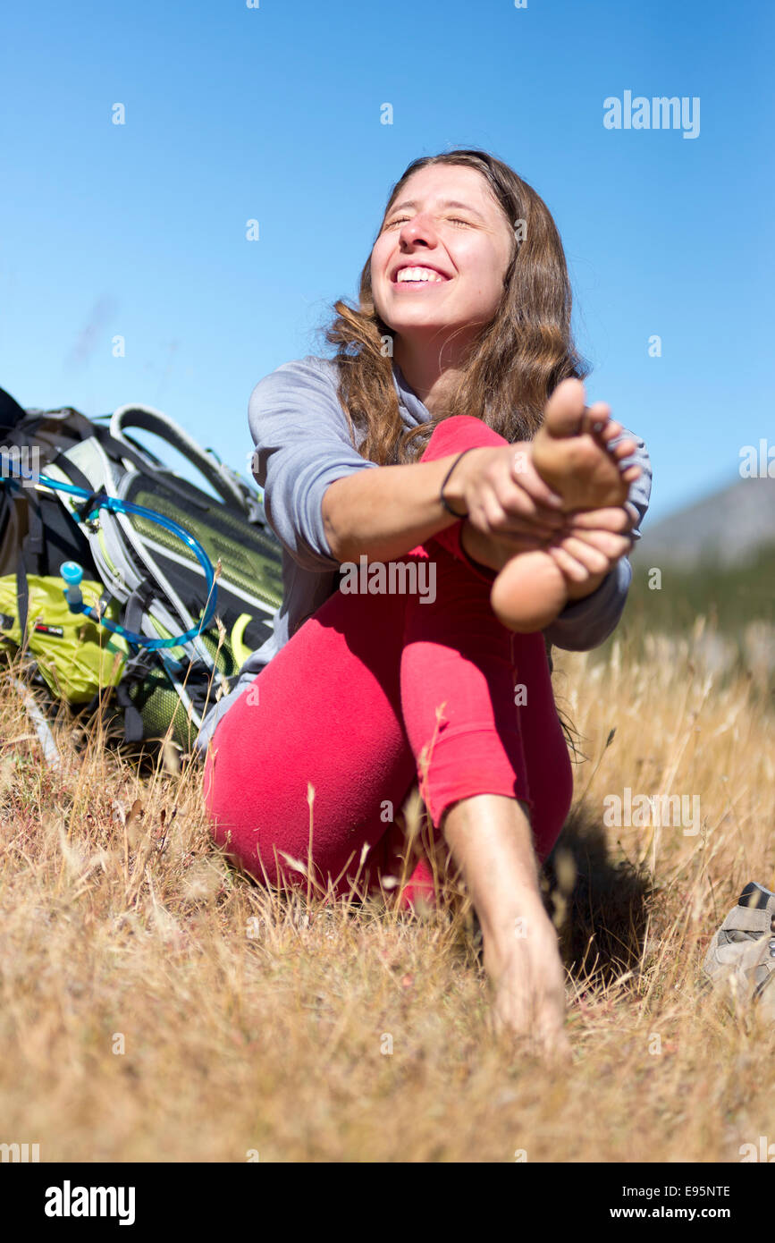 Frau, reiben ihre Füße auf einen Rucksack Reise in Oregon Wallowa Mountains. Stockfoto