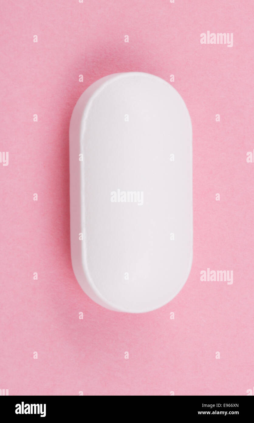 Weiße Pille auf rosa Hintergrund Stockfoto