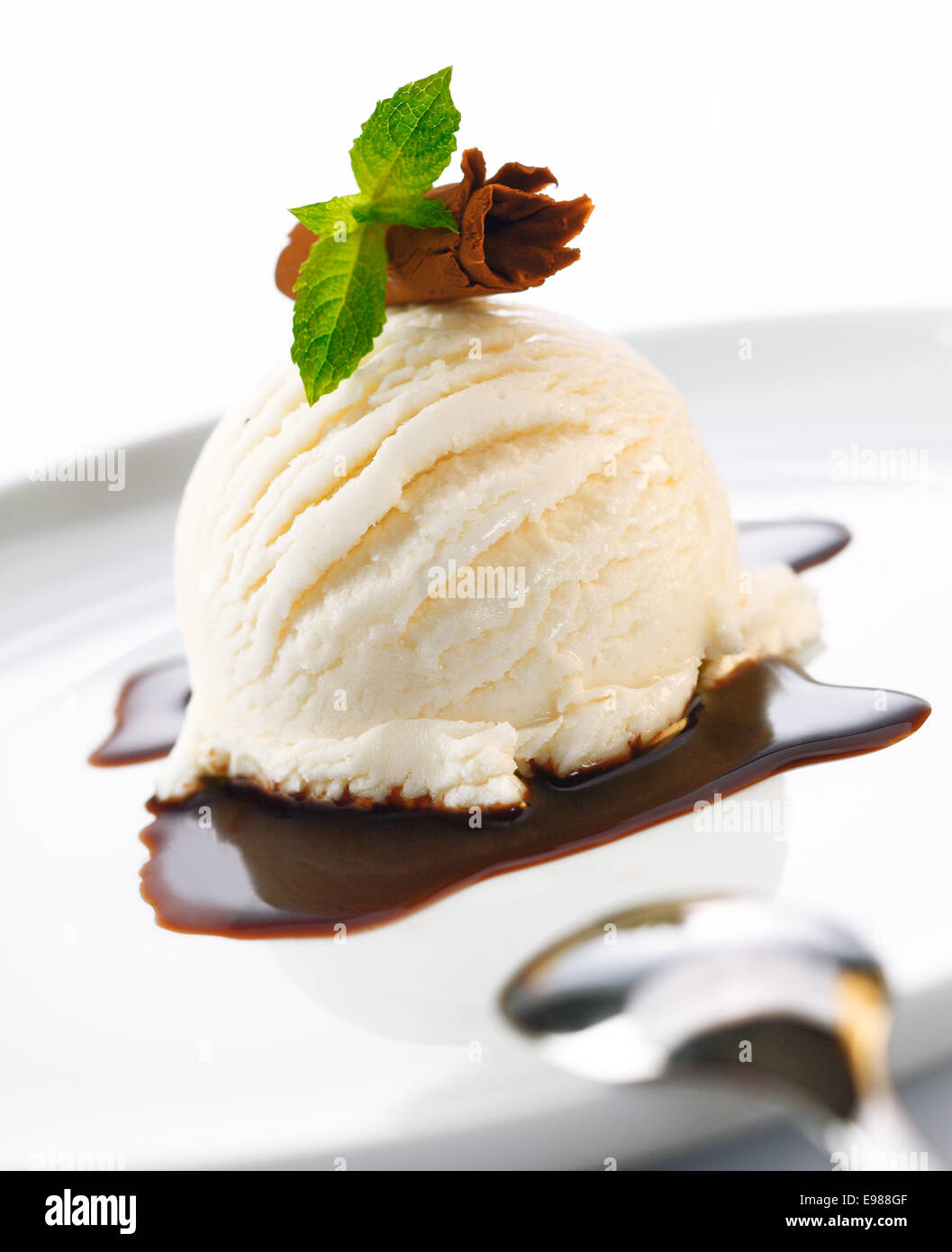 Portion Eis Und Heisser Schokoladensauce Garniert Mit Gehobeltem Schokolade Und Minze Stockfotografie Alamy