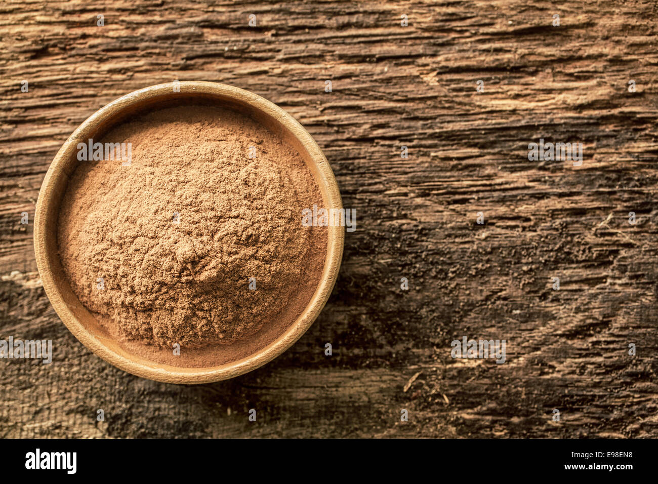 Schüssel mit Zimtpulver, Boden Gewürz aus Rinde und in süßen und herzhaften Gerichten auf Grunge Holz Hintergrund mit Exemplar verwendet Stockfoto