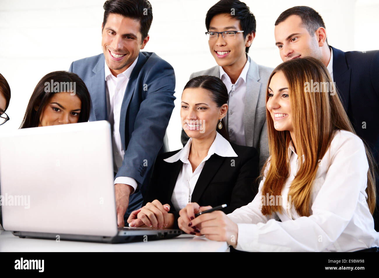 Lächelnde Geschäftsleute, die gemeinsam auf dem laptop Stockfoto