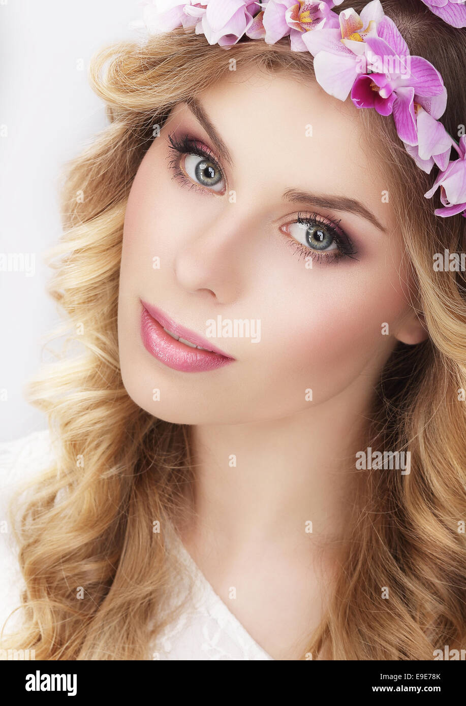 Charming Girl in Kranz aus Blumen Stockfoto