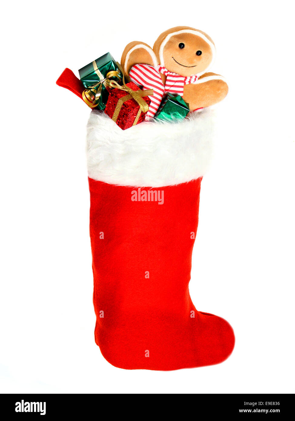 Weihnachts-Strumpf voller Geschenke und Spielzeug auf einem weißen Hintergrund Stockfoto