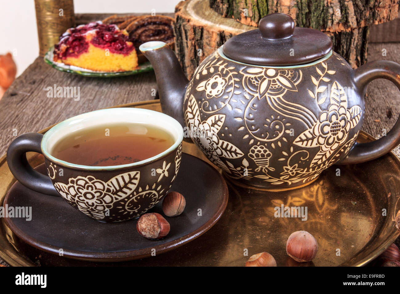 Stillleben mit heißem Tee Cup in Herbst Dekoration mit den Muttern an einem alten Holztisch Stockfoto
