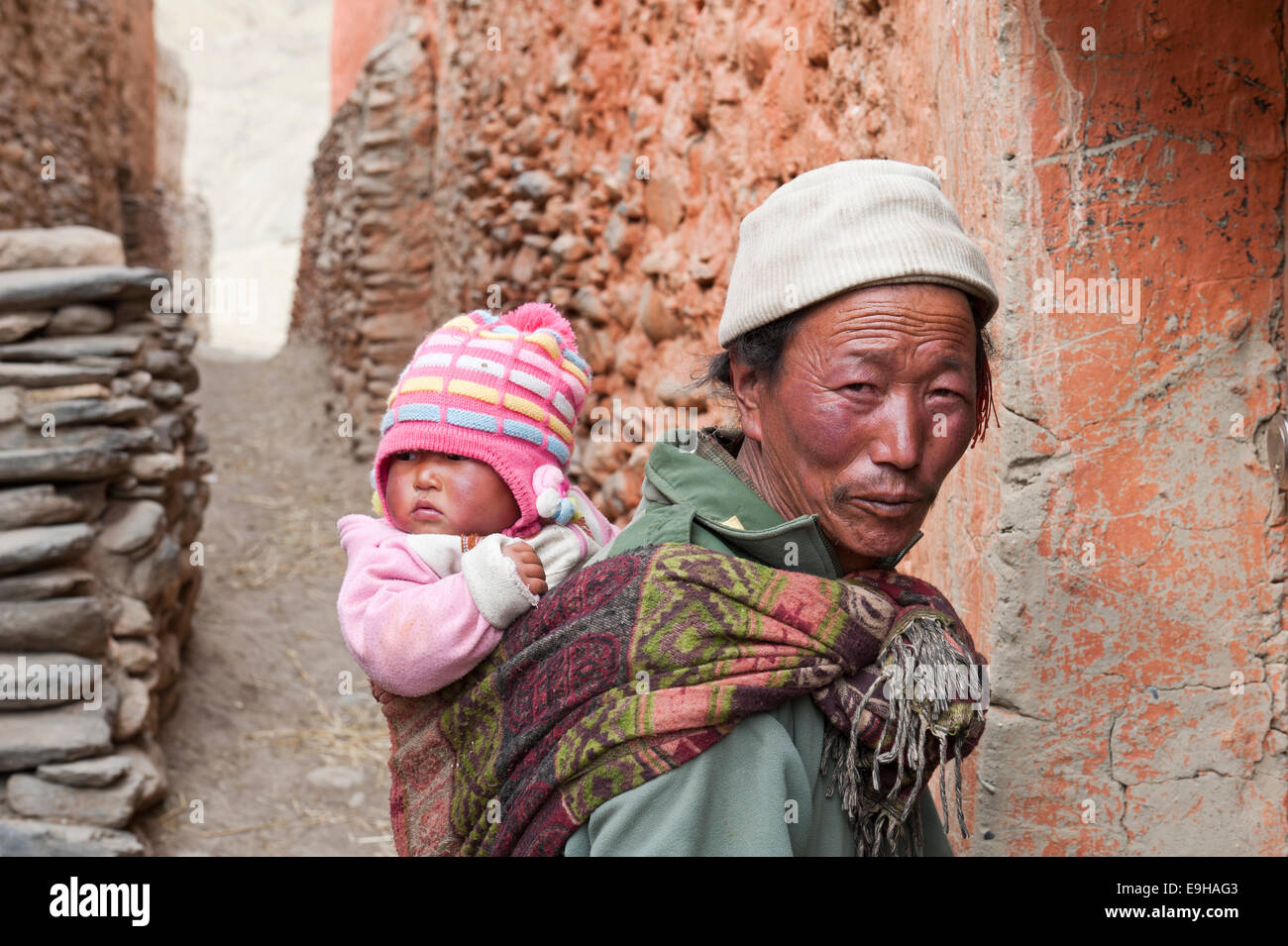 Mann trägt ein Baby auf seiner Rückseite, ethnische Gruppe der Lopa, Lo oder Mustang, Nepal Stockfoto