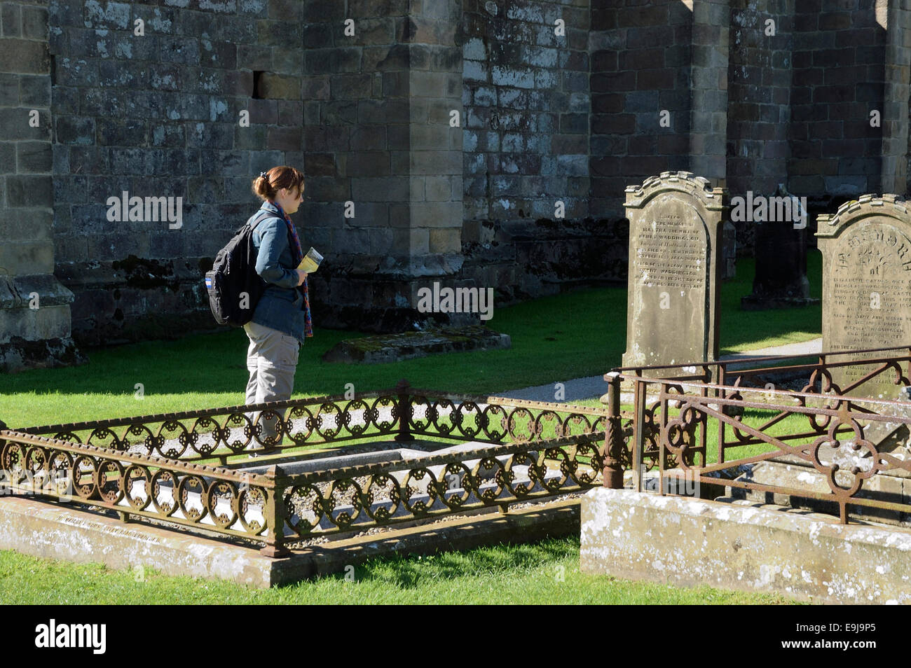 Touristen, die Grabsteine in Bolton Abbey, North Yorkshire, England 030913 0259 lesen Stockfoto