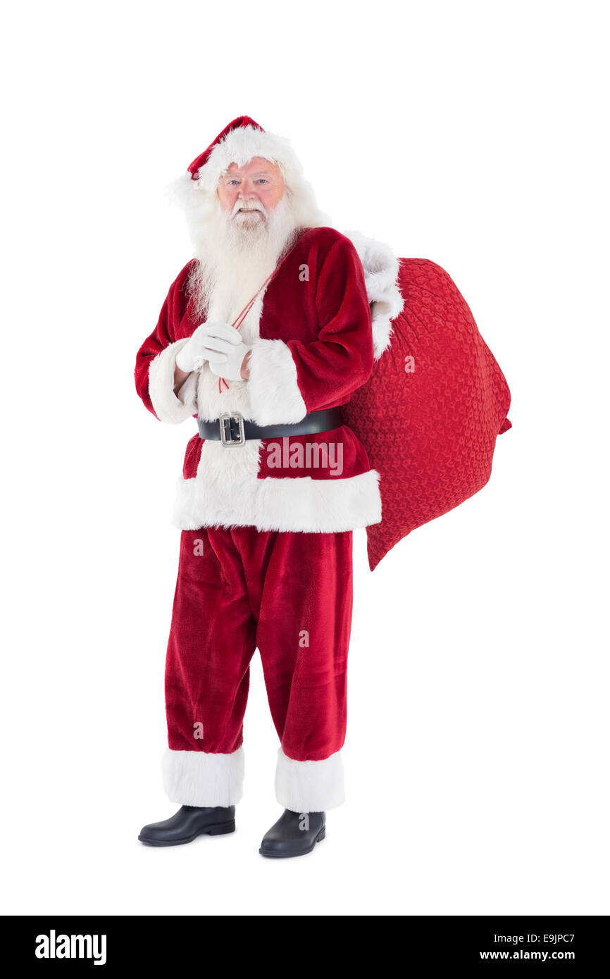 Santa trägt seine rote Tasche Stockfoto