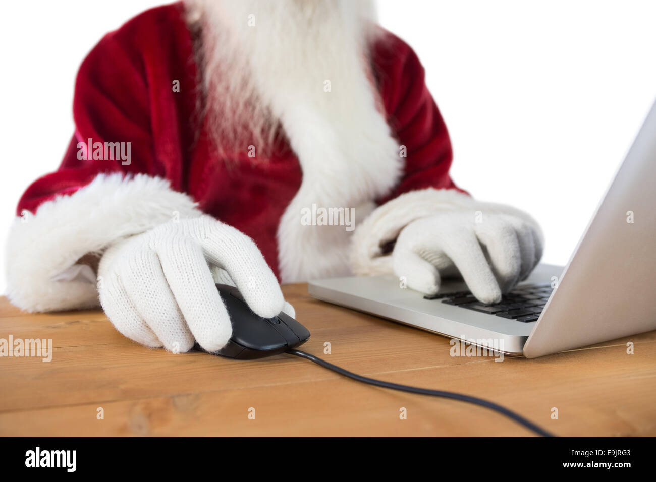 Santa surft im Internet Stockfoto