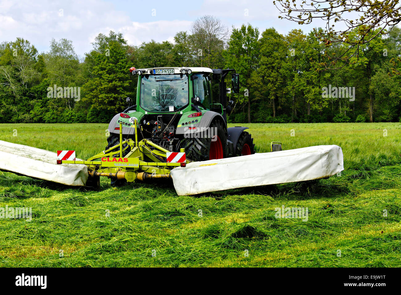 Bayerischen Bauernhof Traktor Mähen Feld, Chiemgau, obere Bayern Deutschland Europa. Stockfoto