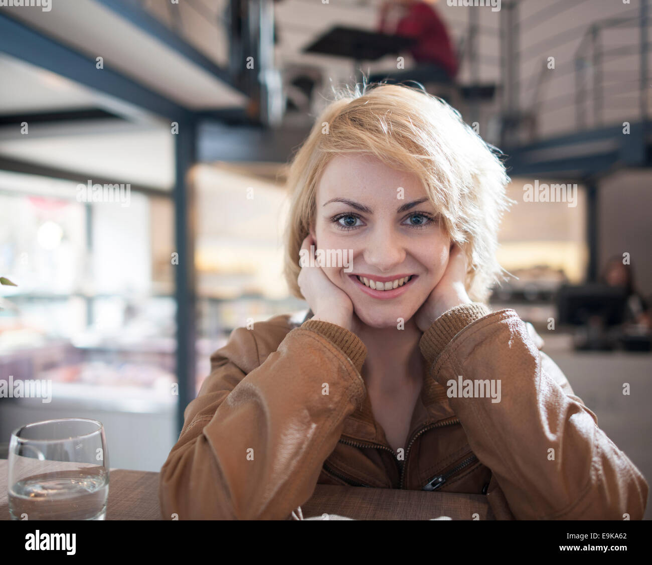 Porträt der schönen jungen Frau lächelnd in café Stockfoto