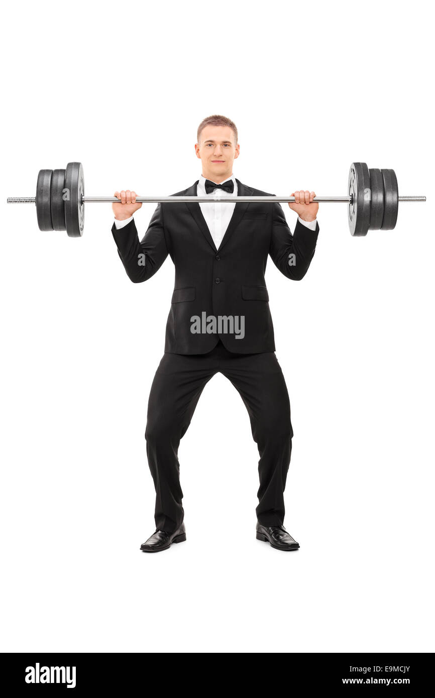 In voller Länge Portrait eines eleganten Mannes hält ein schweres Gewicht isoliert auf weißem Hintergrund Stockfoto