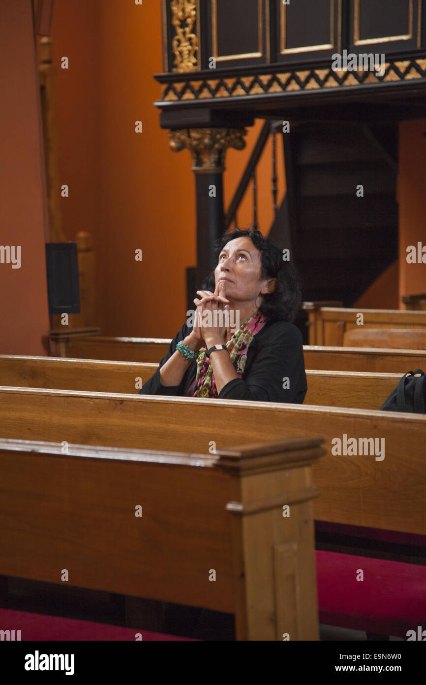Frau tief im Gebet in einer katholischen Kirche.  Zielona Gora, Polen. Stockfoto