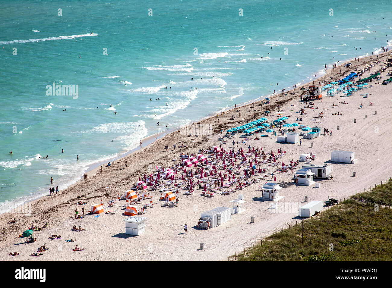 Luftaufnahme der Sonnenanbeter, Schwimmer, Surf und Cabanas am South Beach, Miami Beach, Florida, USA. Stockfoto