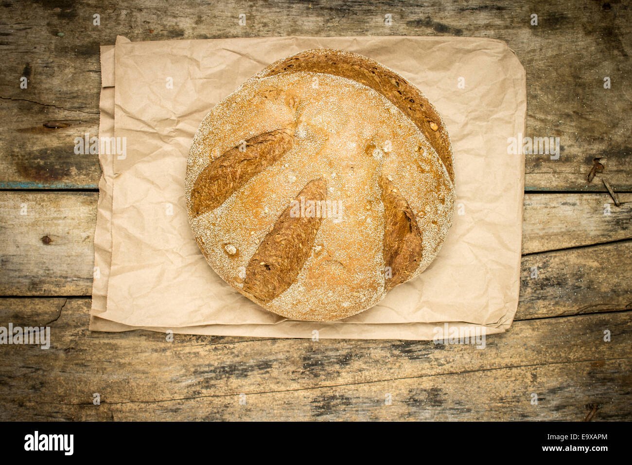 Laib frisch gebackenes Weizen Brot auf verwittertem Holz Tisch. Draufsicht Bäckerei Hintergrund Stockfoto