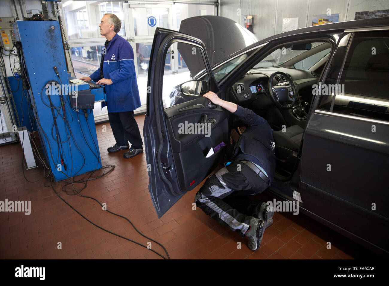 Berlin, Deutschland. 4. November 2014. Ein Mitarbeiter des TÜV, der Technische Überwachungsverein für Autos und Consumer-Produkte, Insepects ein Auto bei der TÜV Prüfung und Service-Station in Berlin, Deutschland, 4. November 2014. Foto: Jörg Carstensen/Dpa/Alamy Live News Stockfoto