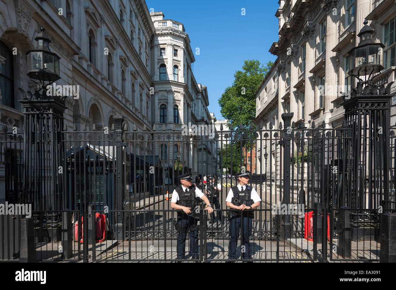 Polizisten im Dienst an den Toren zu 10 Downing Street, Prime Minister Büros, Whitehall, London, England, Vereinigtes Königreich Stockfoto