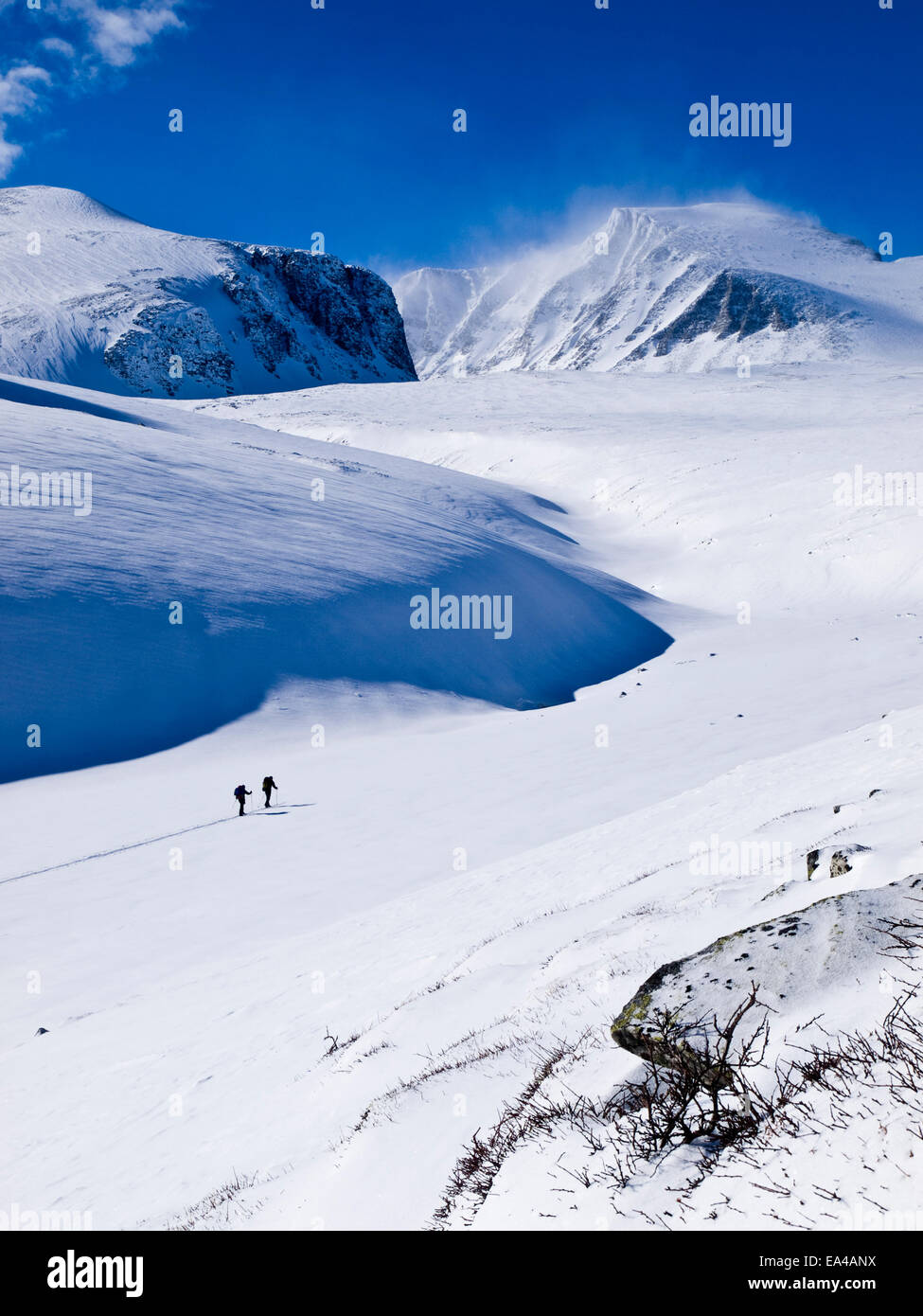 Großen Schnee bedeckte Berge und blauer Himmel mit zwei Ski-Tourer in Rondane Berge, Norwegen Stockfoto