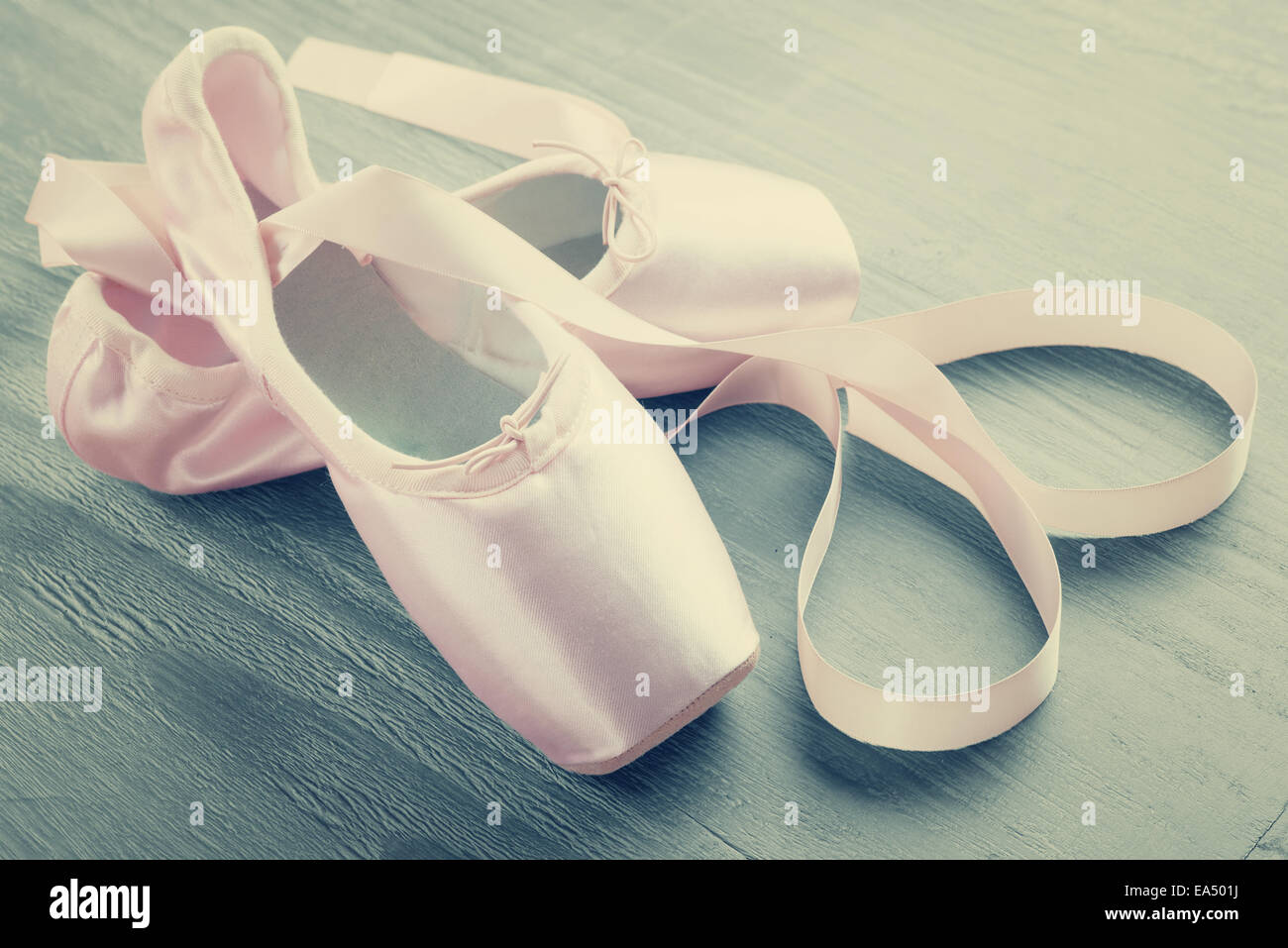 neue rosa Ballett Spitzenschuhe auf hölzernen Hintergrund im Vintage-Stil Stockfoto