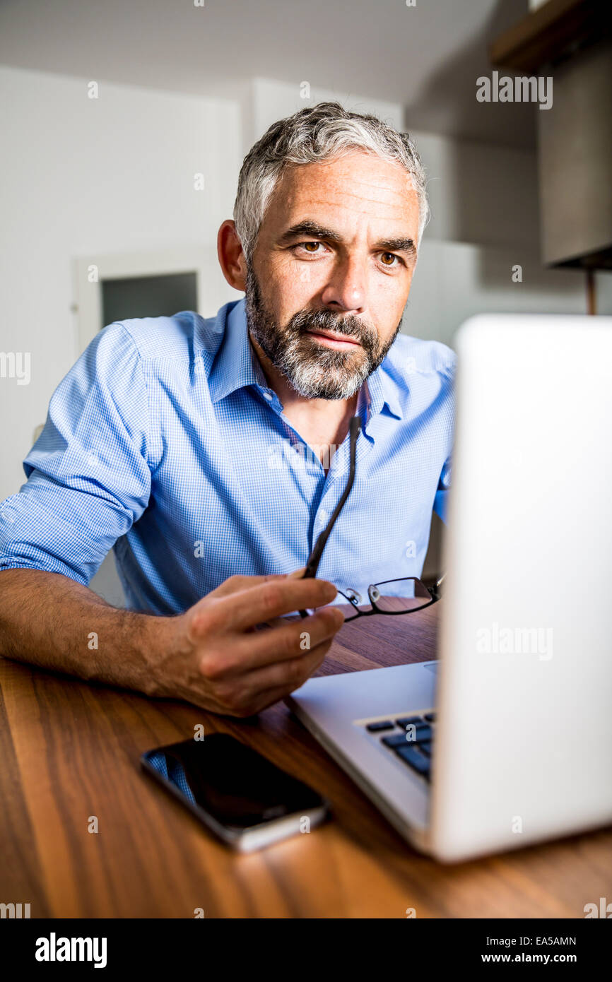 Porträt der Geschäftsmann arbeiten mit Laptop zu Hause Büro Stockfoto