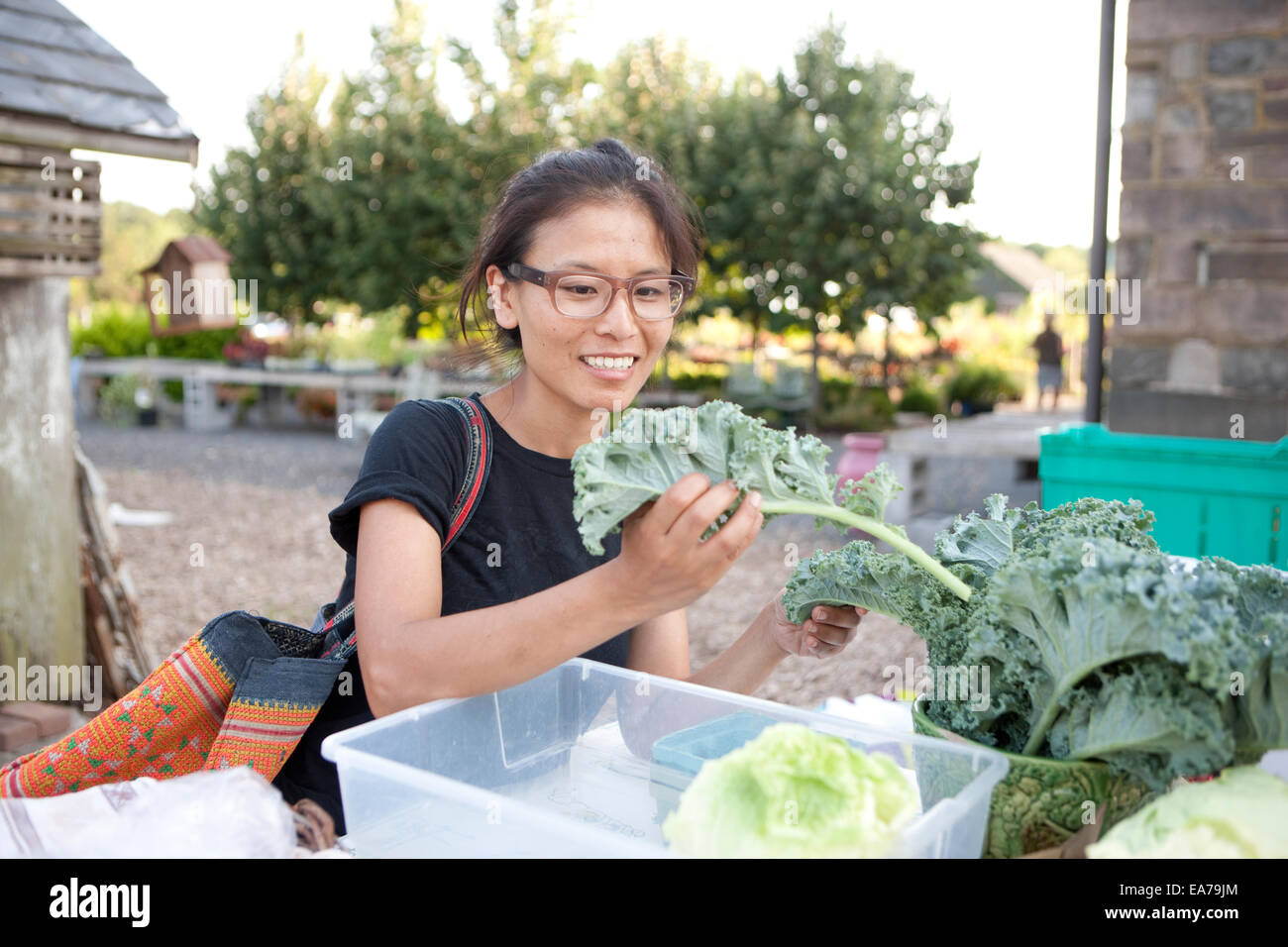 Junge Frau Wahl Salat auf Open-Air-Markt Stockfoto