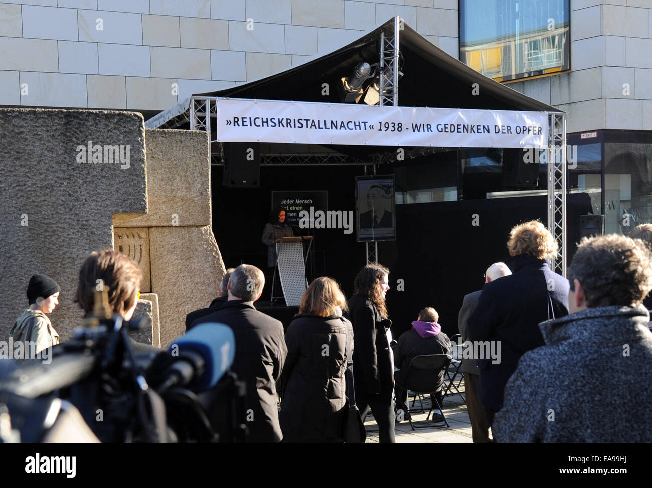 München, Deutschland. 9. November 2014. Besucher folgen die Lesung der Namen der Münchner jüdischen Glaubens auf einen Gedenkstein an der Hauptsynagoge in München, 9. November 2014. Die Lesung fand statt zum Gedenken an die Pogromes von November 1938 in Deutschland. Foto: Tobias Hase/Dpa/Alamy Live News Stockfoto