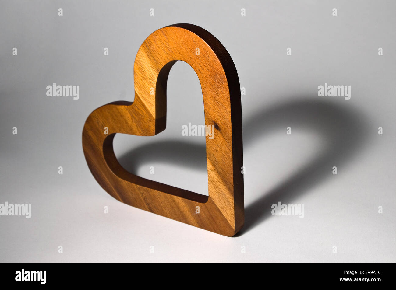 Herz aus Holz mit herzförmigen Schatten Aussehen der zwei Herzen. Stockfoto