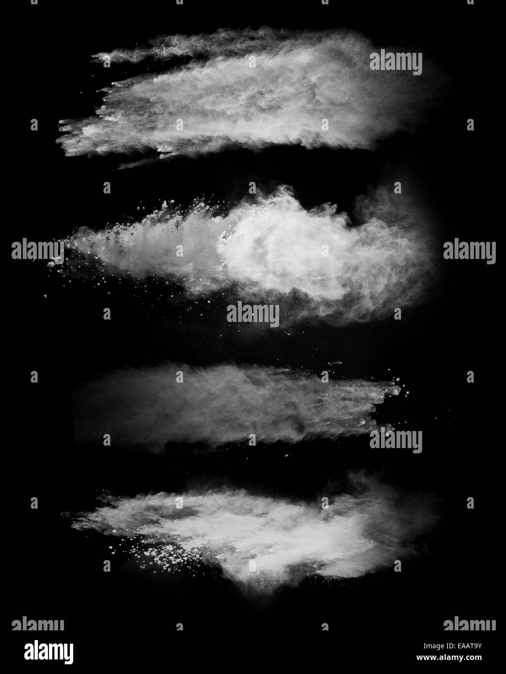Einfrieren der Bewegung von weißen Staubexplosionen auf schwarzem Hintergrund isoliert Stockfoto