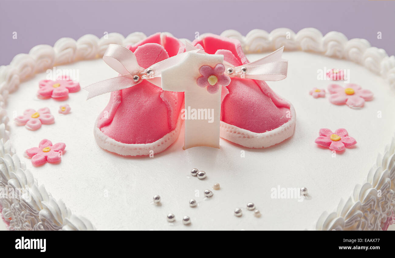 Details einer Geburtstagstorte für Baby Girl, Nummer eins und süße Zucker  Schuhe an der Spitze Stockfotografie - Alamy