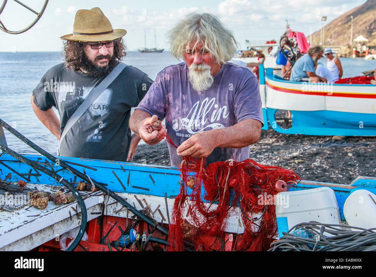 Ein Fischer sein Netz zu reparieren Stockfoto