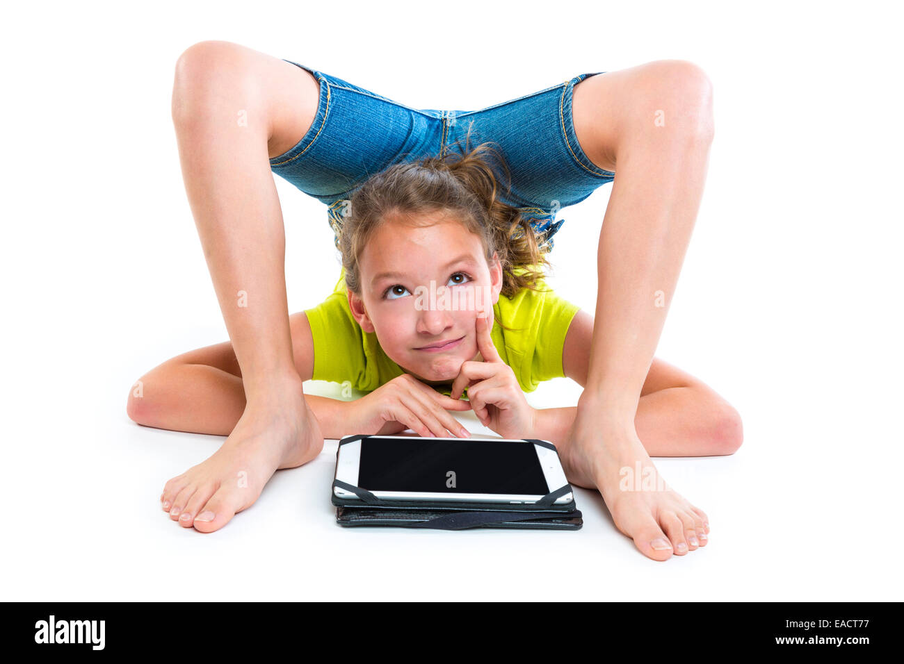 Flexible Schlangenmensch Kind Mädchen denken Geste mit Tablet-pc auf weißem Hintergrund Stockfoto