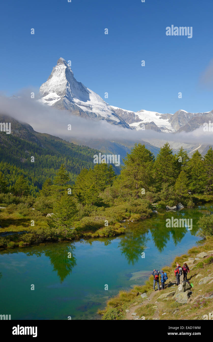 Wanderer, die das Fotografieren des Matterhorns mit See Grindjisee im Vordergrund, Zermatt, Kanton Wallis, Schweiz Stockfoto