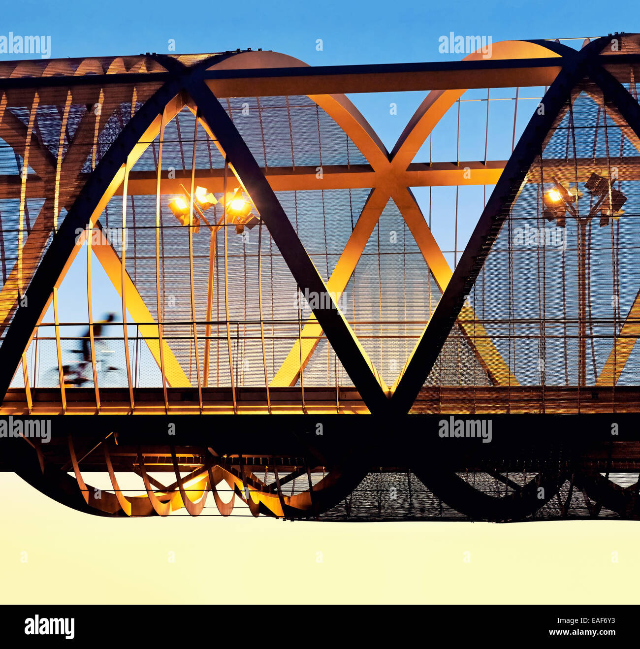 Cyclist passing by the Arganzuela bridge, designed by architect Dominique Perrault. Madrid Rio Park. Madrid. Spain Stockfoto