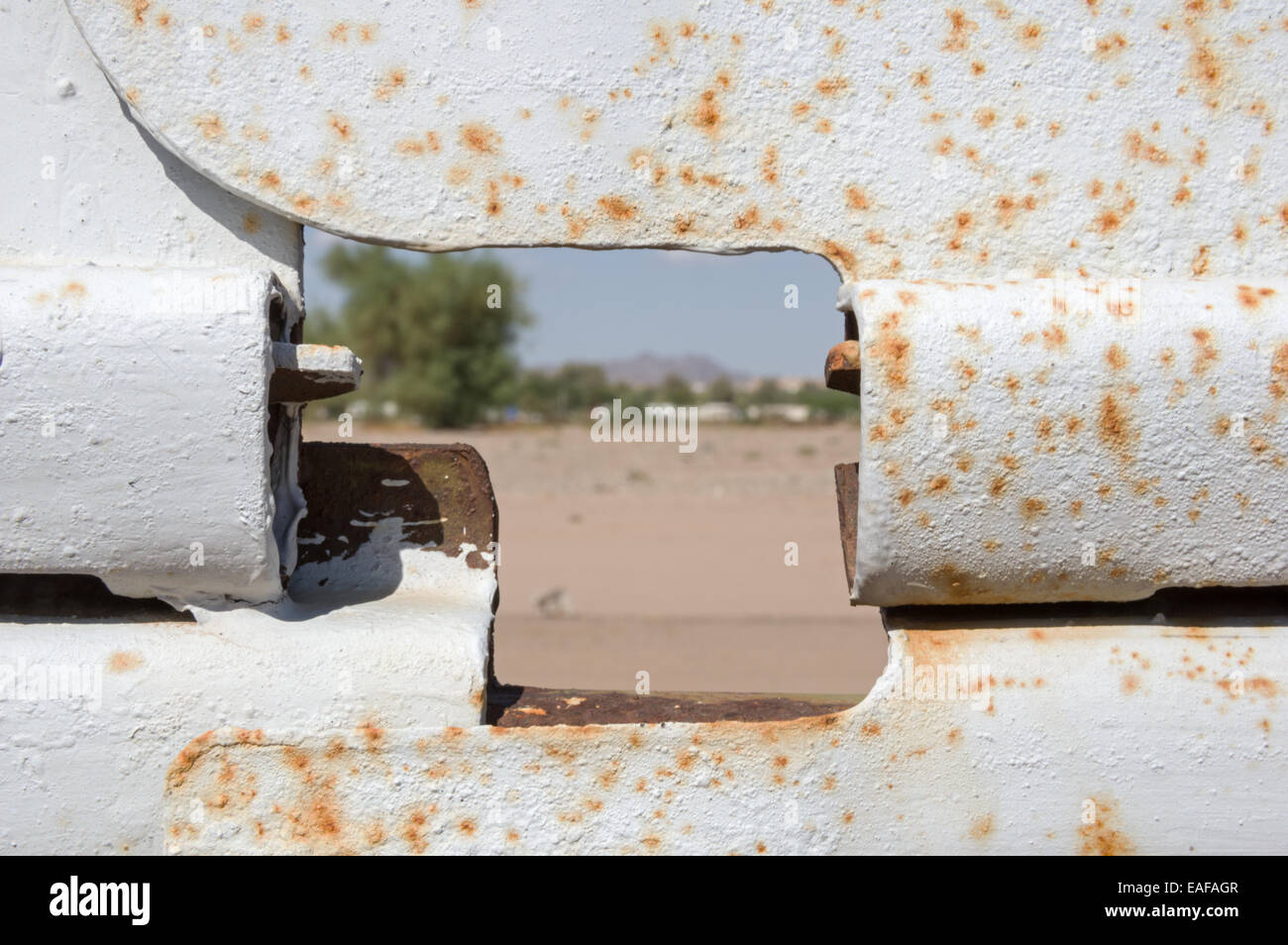 Blick durch ein Loch in den USA Grenzzaun aus Mexiko in die USA mit dem Fokus auf dem Zaun Stockfoto