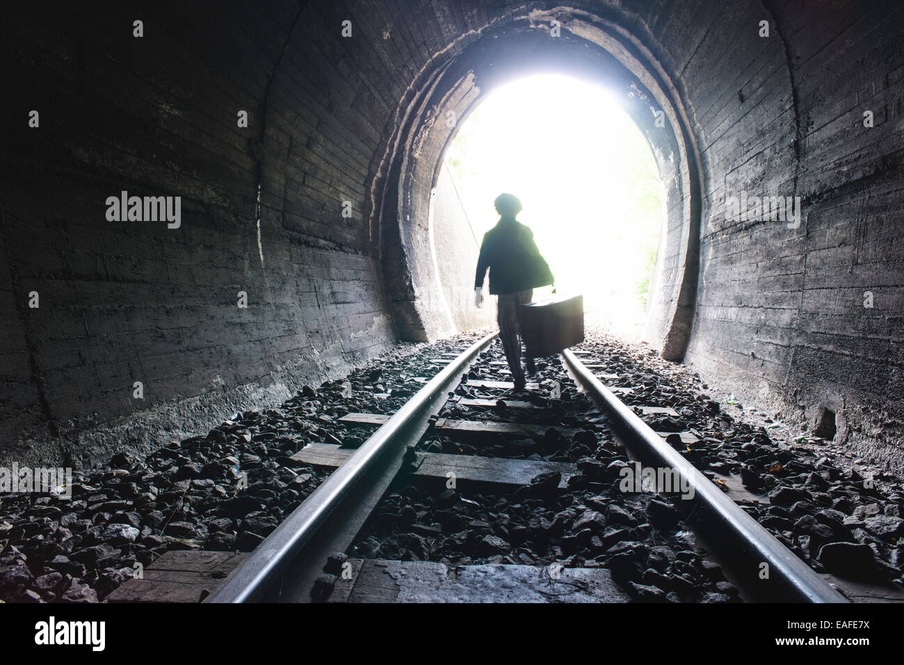 Kind zu Fuß im Eisenbahntunnel. Vintage-Kleidung Stockfoto
