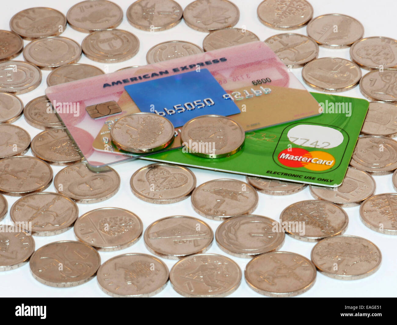 Haufen von Münzen mit Kreditkarten - American Express und mastercard Stockfoto