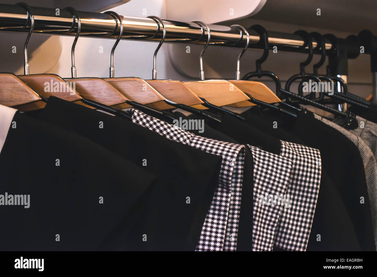 Kleidung auf Bügeln im Shop. Nahaufnahme Stockfoto